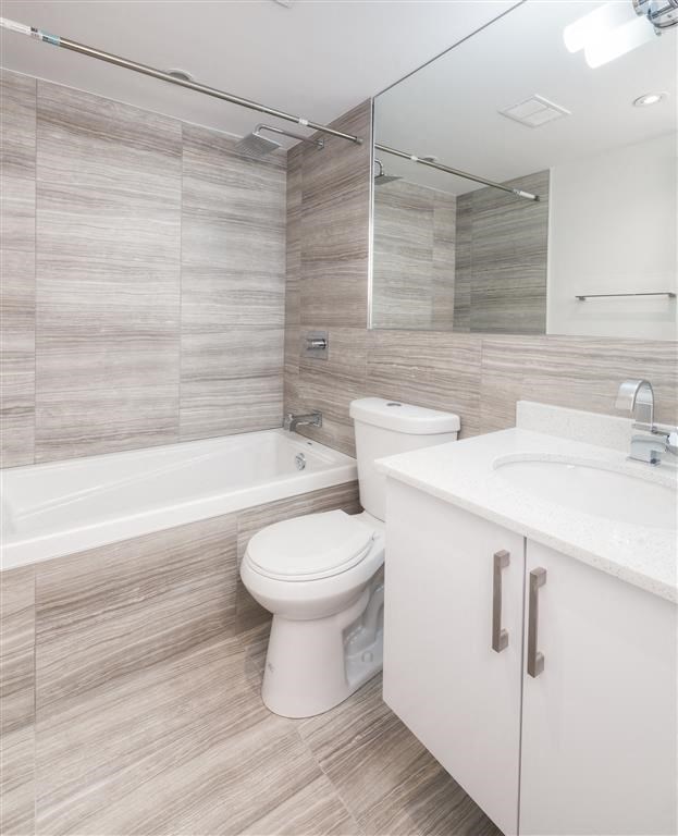 a bathroom with a toilet sink and a mirror