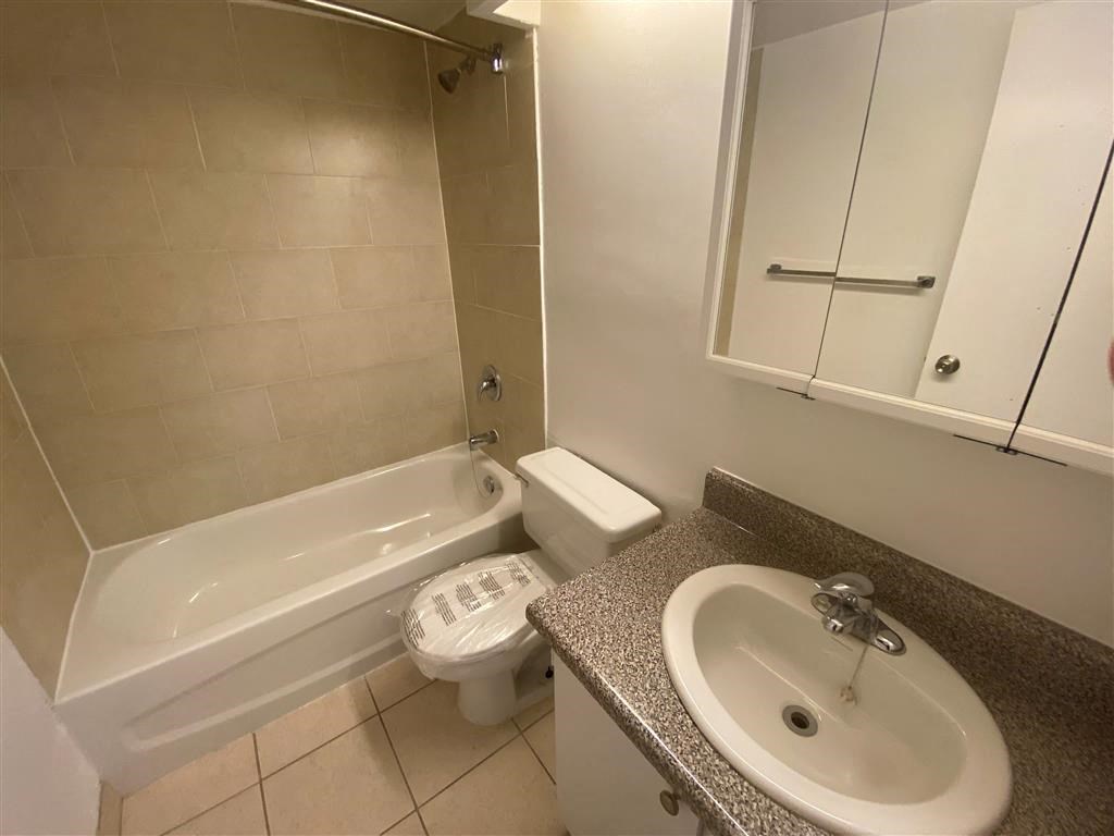 a bathroom with a sink toilet and a bath tub
