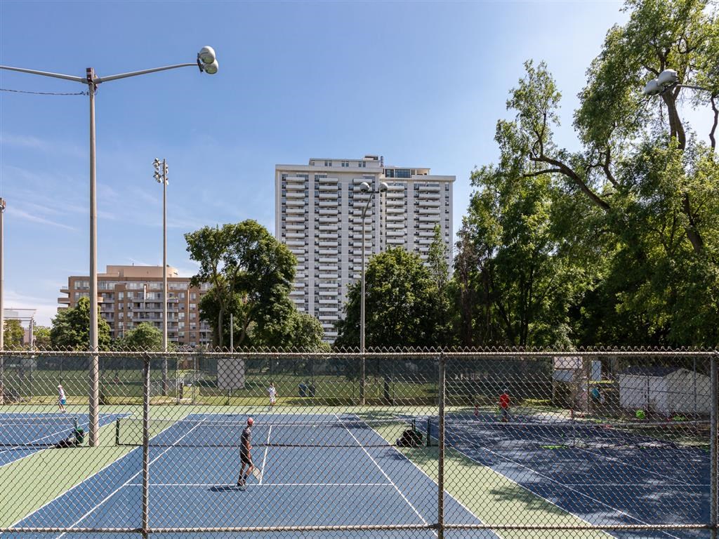 a group of people playing tennis on a tennis court