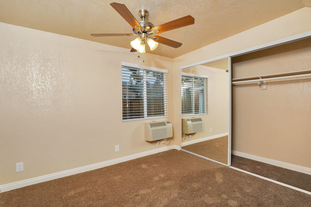 a room with a ceiling fan and a window