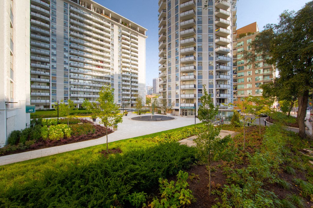 a view of a park with buildings in the background