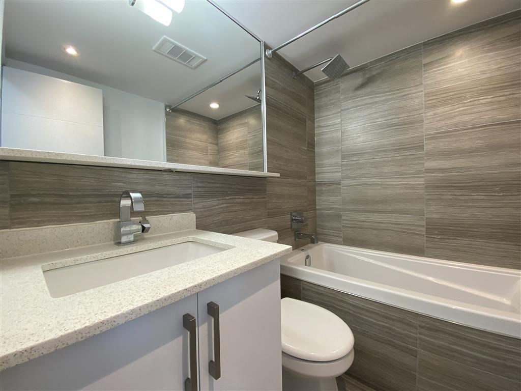 a bathroom with a sink toilet and a bath tub