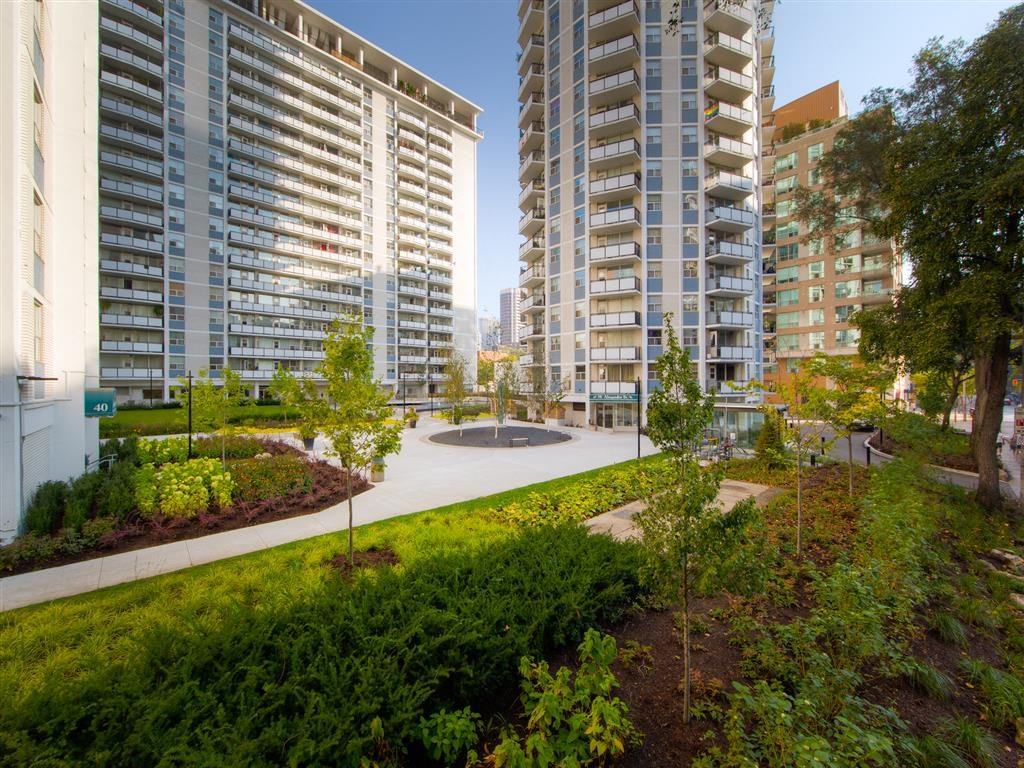 a view of a park with buildings in the background