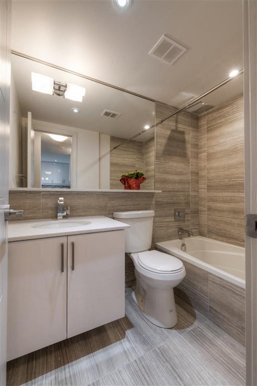 a bathroom with a toilet and a sink and a bath tub