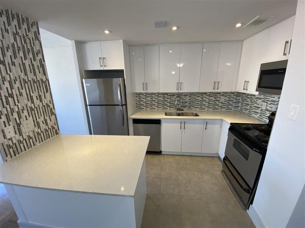 a kitchen with white cabinets and a counter top