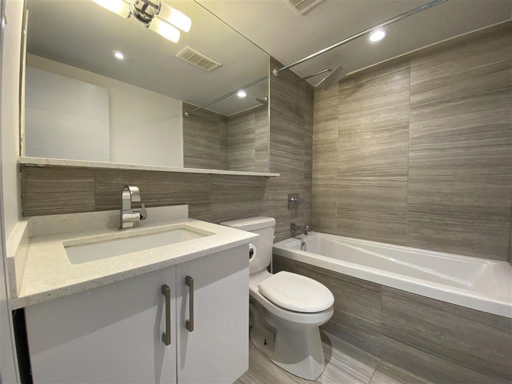 a bathroom with a sink toilet and a bath tub