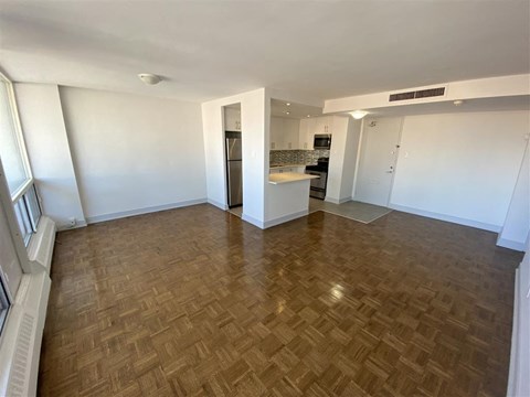 an empty living room and kitchen in an empty apartment