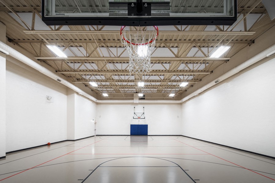 A basketball court with a hoop and a blue box in the middle.