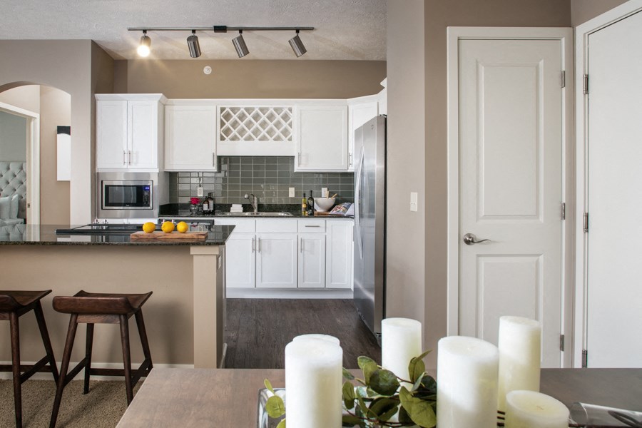 A kitchen with a counter and bar stools.