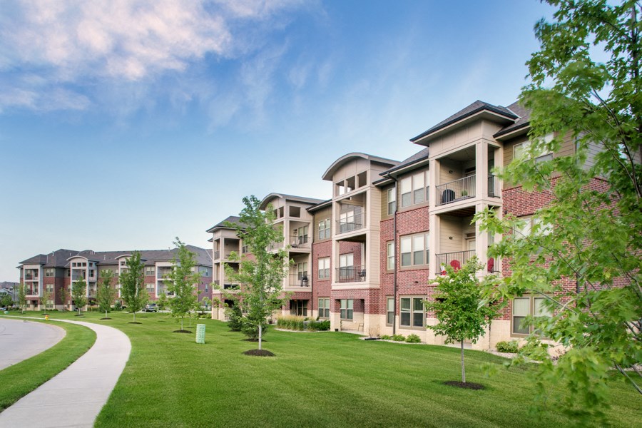 Apartment complex with a green lawn in front.