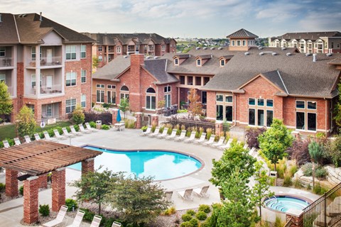 A large brick building with a pool in the middle of it.