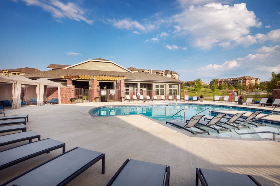 A pool area with a building in the background.