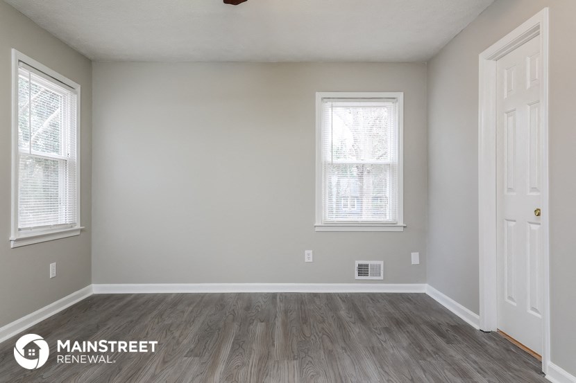 the interior of a renovated room with wood floors and white walls