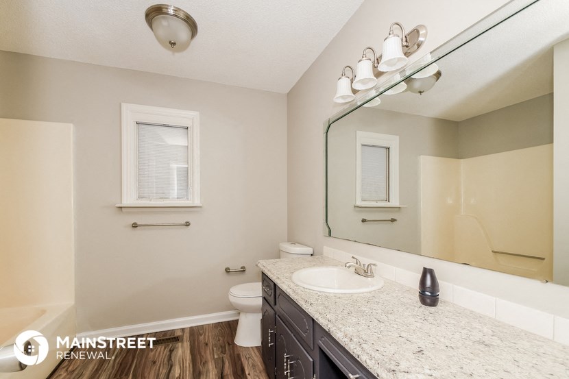 a bathroom with a sink and a toilet and a mirror