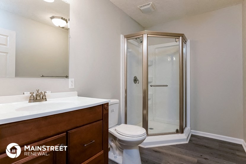 a bathroom with a toilet sink and a shower
