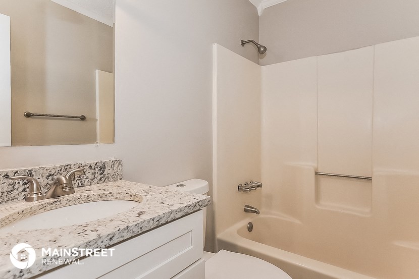a bathroom with a sink and a toilet and a bath tub