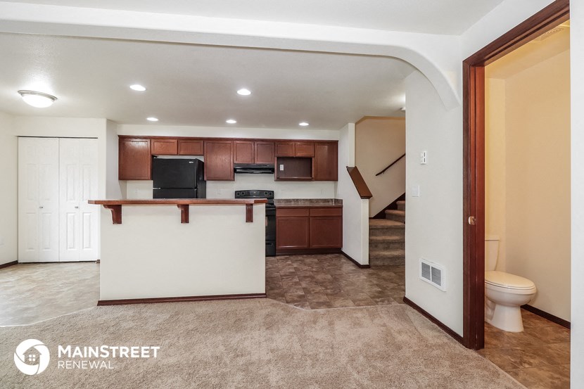 the kitchen is open to the living room and dining room