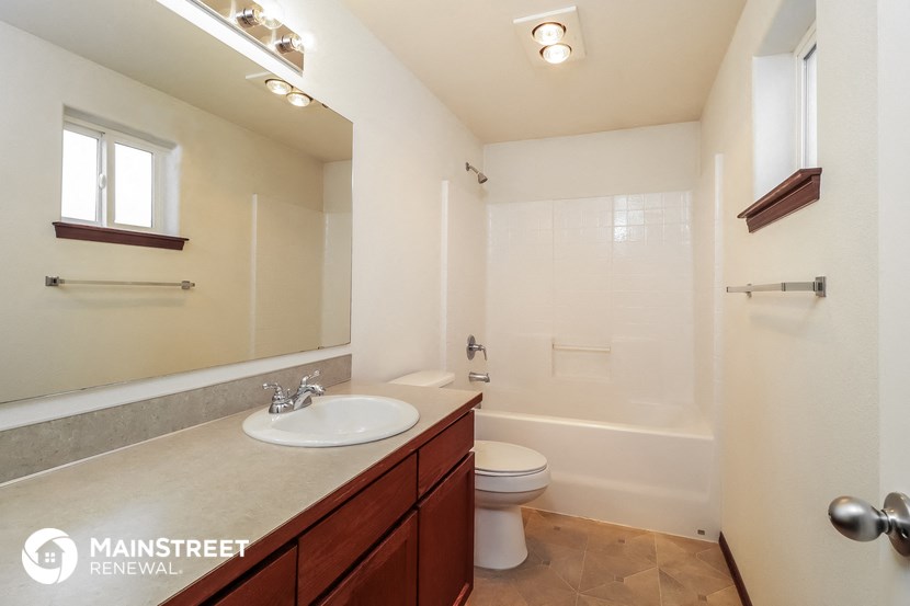 a bathroom with a sink and a toilet and a shower