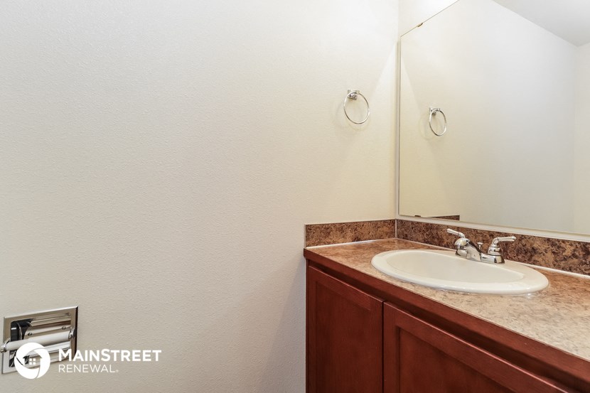 a small bathroom with a sink and a mirror