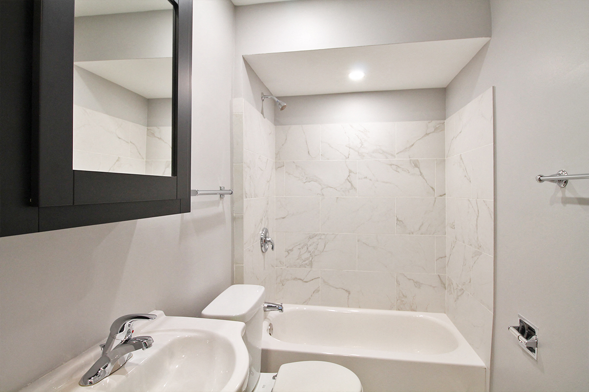 a bathroom with a sink and a toilet and a mirror