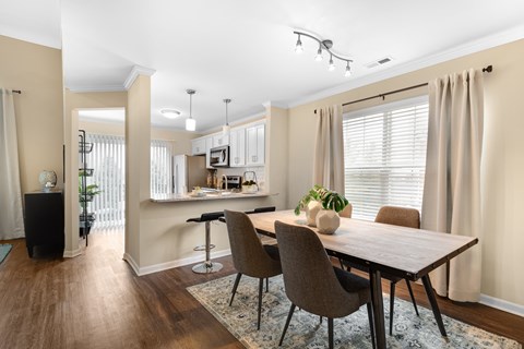 a dining room and kitchen with a table and chairs
