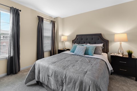 a bedroom with a large bed and two night stands with lamps