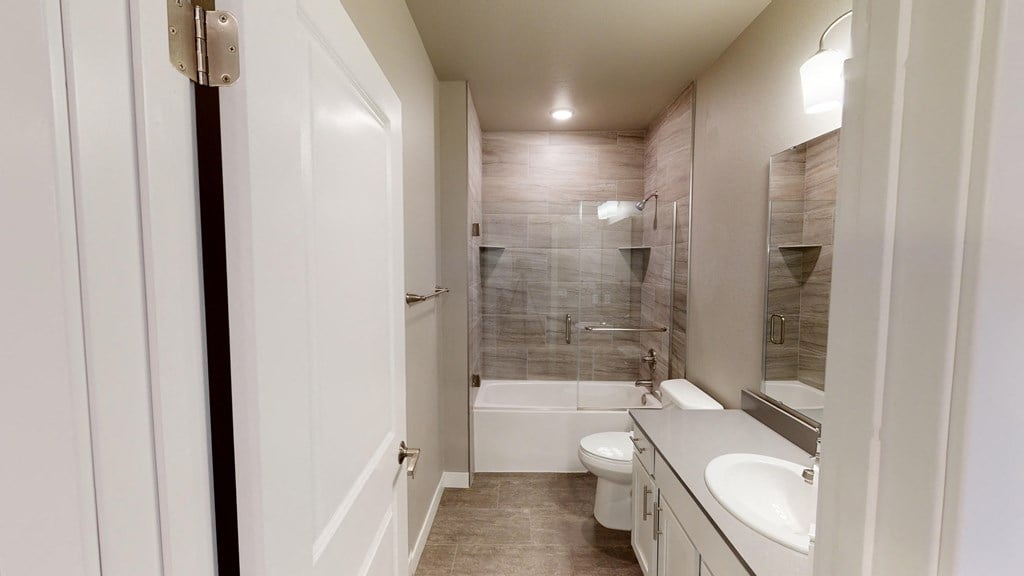 a bathroom with a sink toilet and a shower