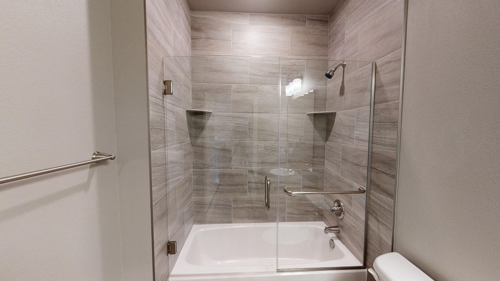 a small bathroom with a shower and a sink