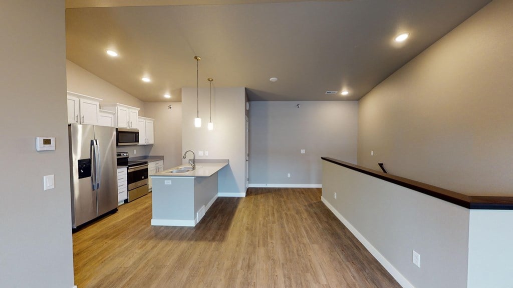 a kitchen with a stainless steel refrigerator and a counter top