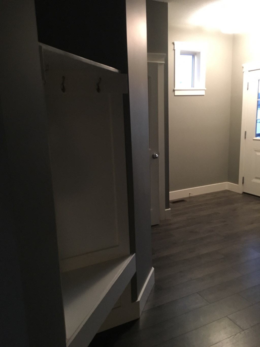 a view from the kitchen into the living room with the door open