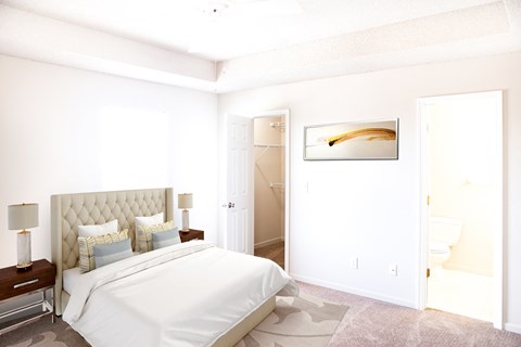 a bedroom with a white bed and a white closet