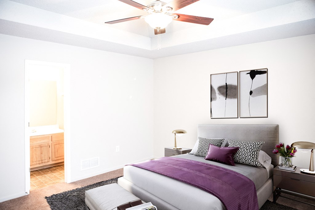 a bedroom with a bed and a ceiling fan