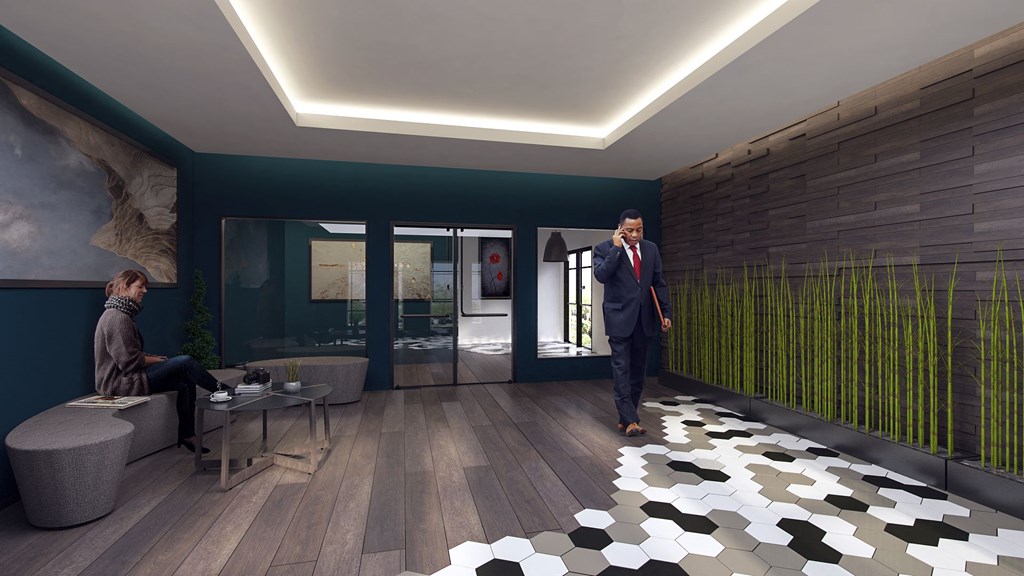 a man in a suit walking through a lobby