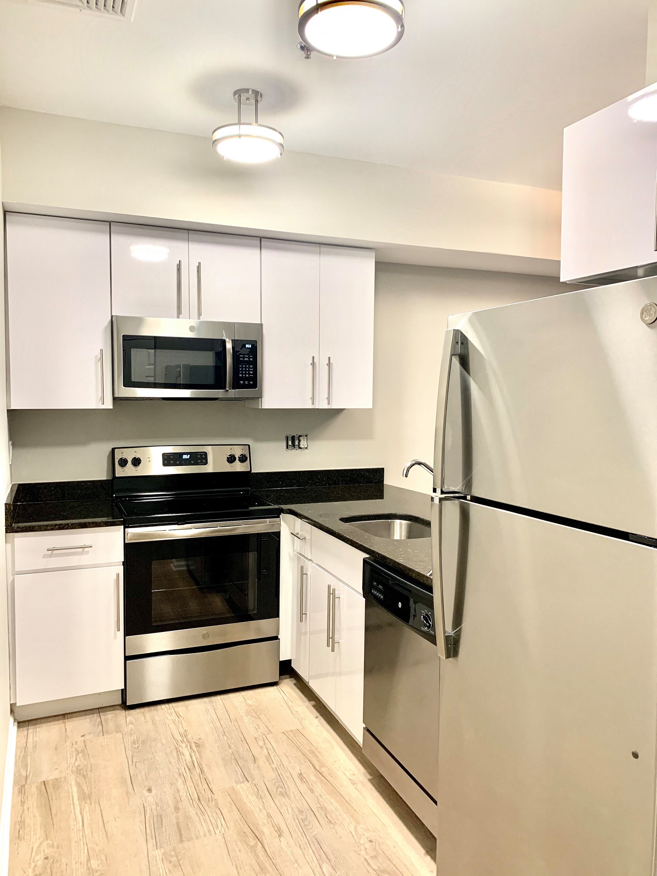a kitchen with stainless steel appliances and white cabinets