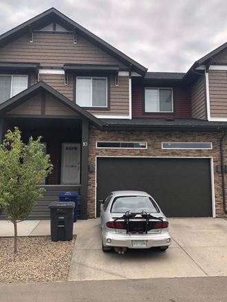 our car parked in front of our house in the driveway