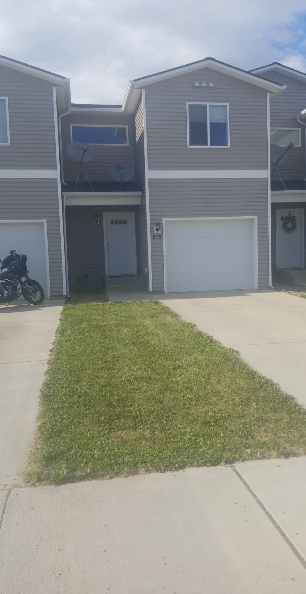 A grey house with a white garage door.