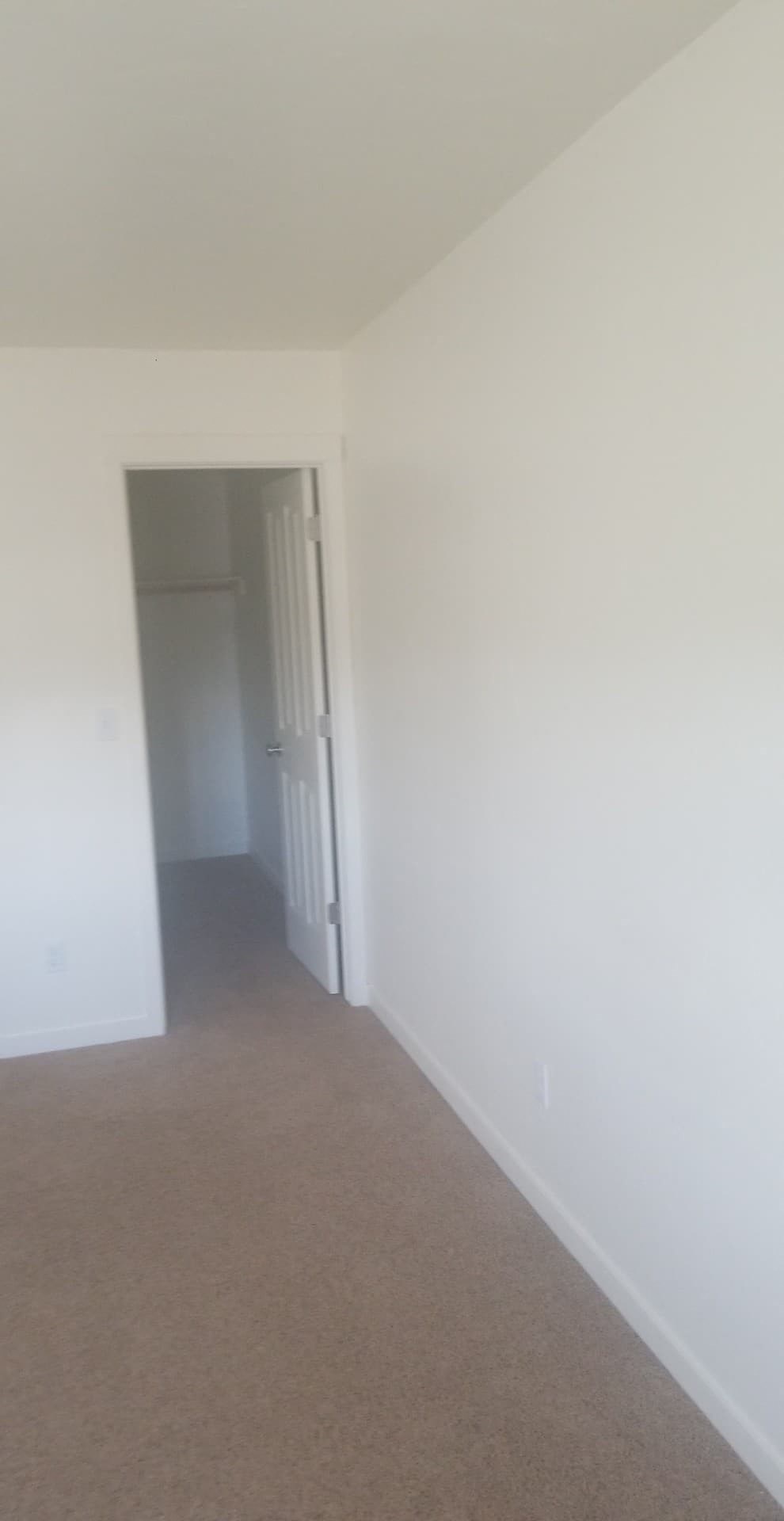 A hallway with a door at the end.
