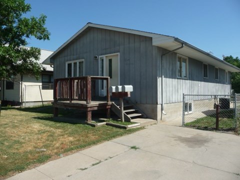 a house with a wooden deck in front of it