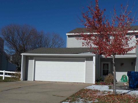 a white garage door in front of a house