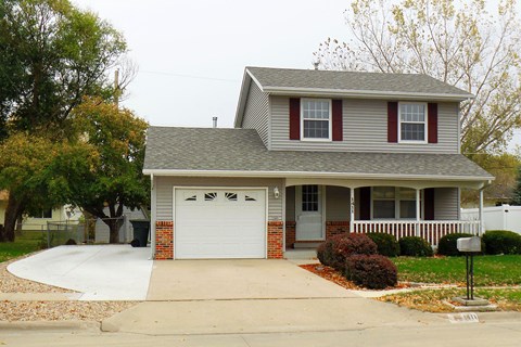 a house with a driveway and a white garage door