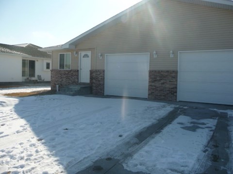 a house with a driveway covered in snow