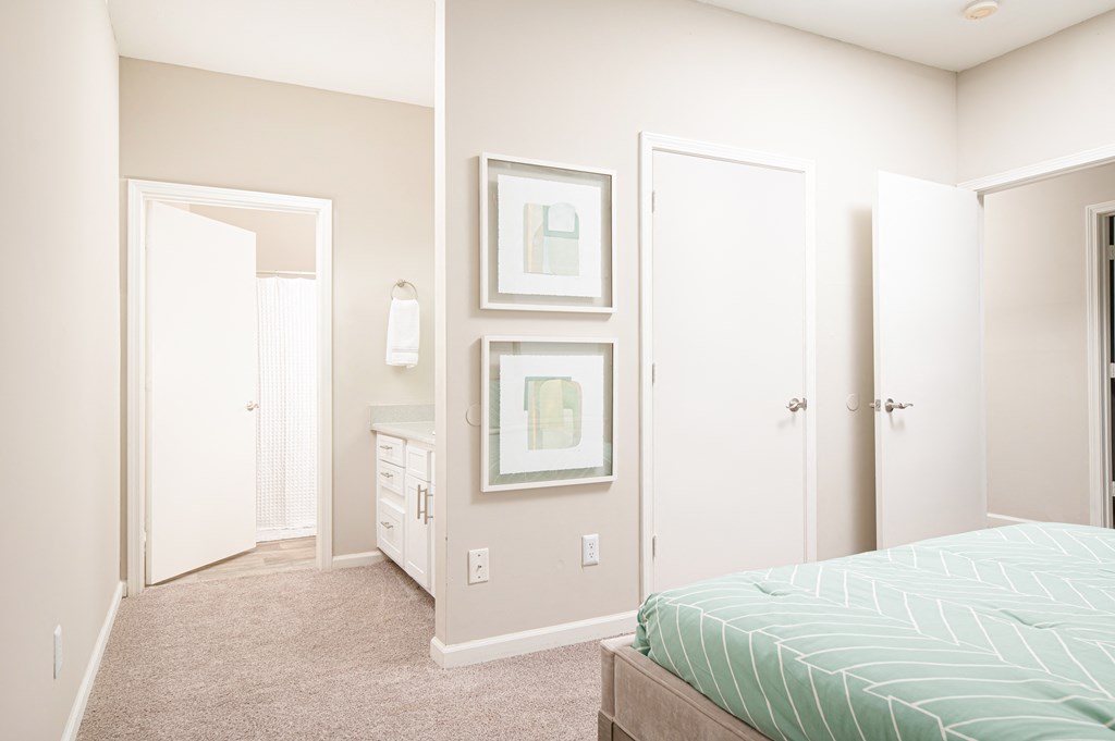 a bedroom with a bed and a closet and a mirror