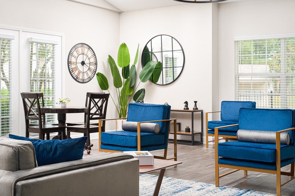 a living room with blue chairs and a table