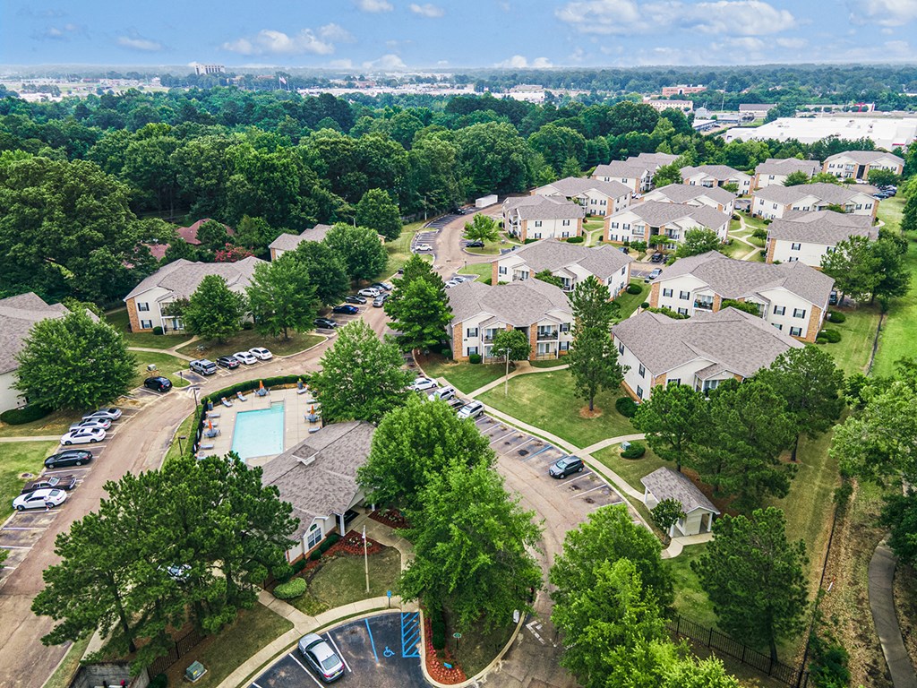 an aerial view of a neighborhood with houses and a swimming pool