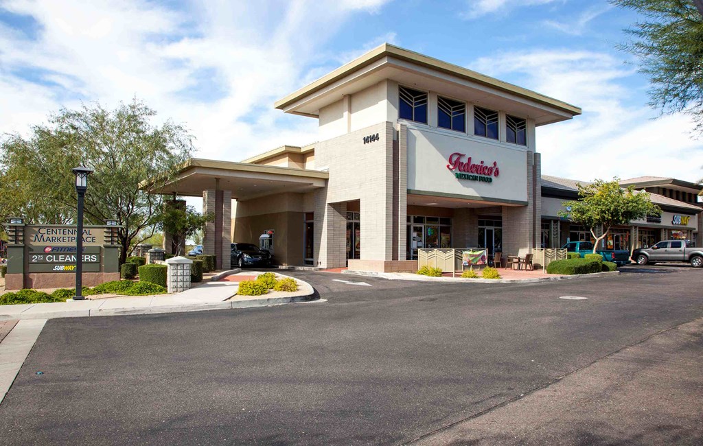 the exterior of a hotel with a parking lot