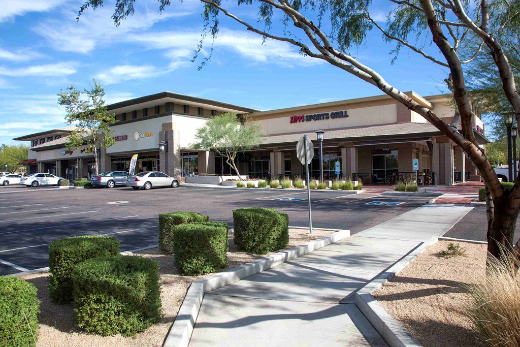 an office building with a parking lot and a stop sign