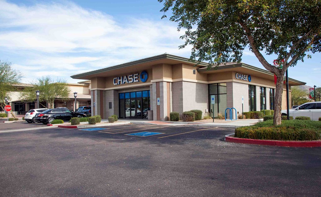 the facade of a chase bank with cars parked outside