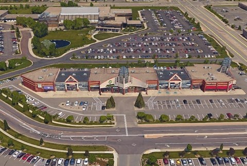 A parking lot with a building in the background.