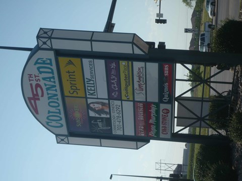 A sign for the 5th Colorado Colonade event is displayed on a pole.