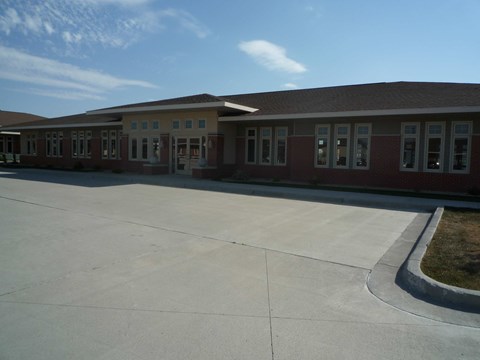 A long building with a lot of windows and doors.
